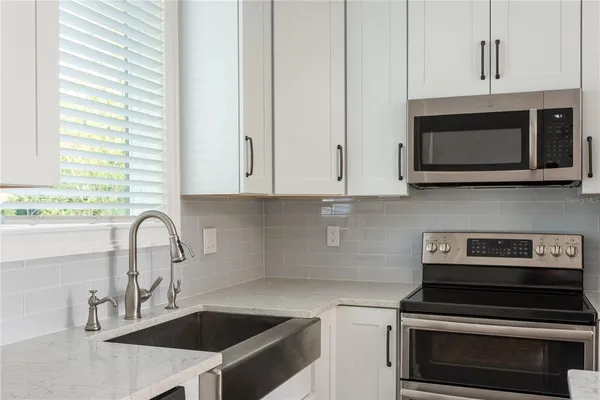 a kitchen with granite countertop a stove and a sink
