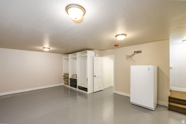 1283 North Gallen Road Santa Clara, UT 84765 - Photo 47 of 103 Finished basement storage area with white epoxy painted flooring and a textured ceiling