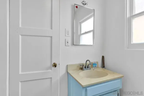 a bathroom with a sink a vanity and a window