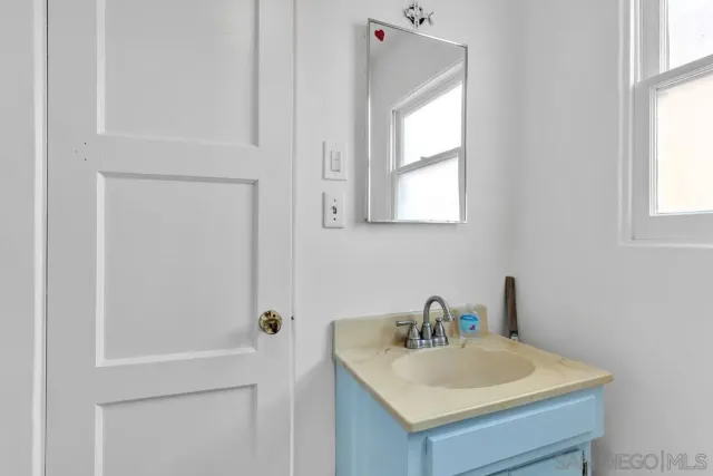 a bathroom with a sink a vanity and a window