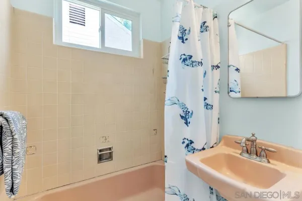 a bathroom with a sink a mirror and a shower