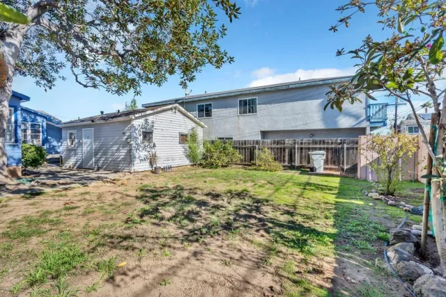a front view of house with yard and trees around