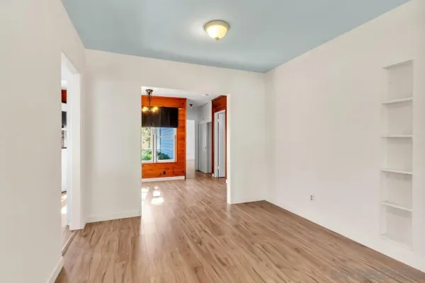 a view of a room with wooden floor and window