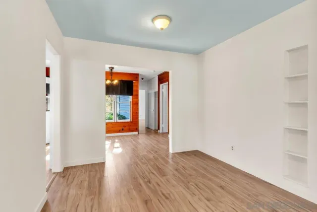 a view of a room with wooden floor and window