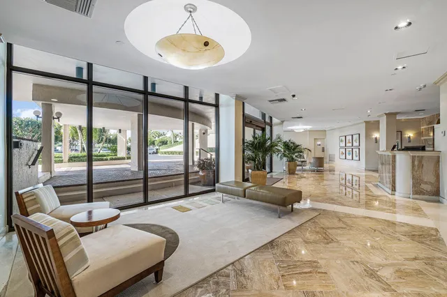 a bedroom with furniture and large windows