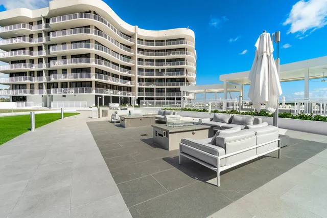 a view of a swimming pool with outdoor seating