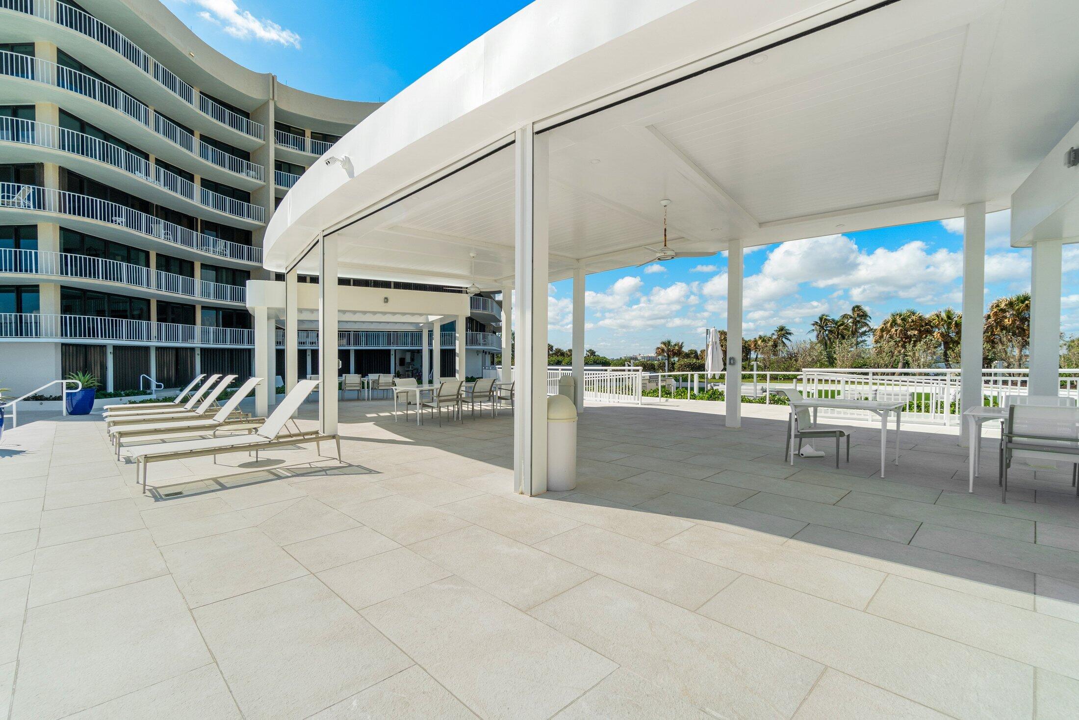 3400 South Ocean Boulevard, Unit 7AII Palm Beach, FL 33480 - Photo 31 of 33 a view of a patio with a table and chairs