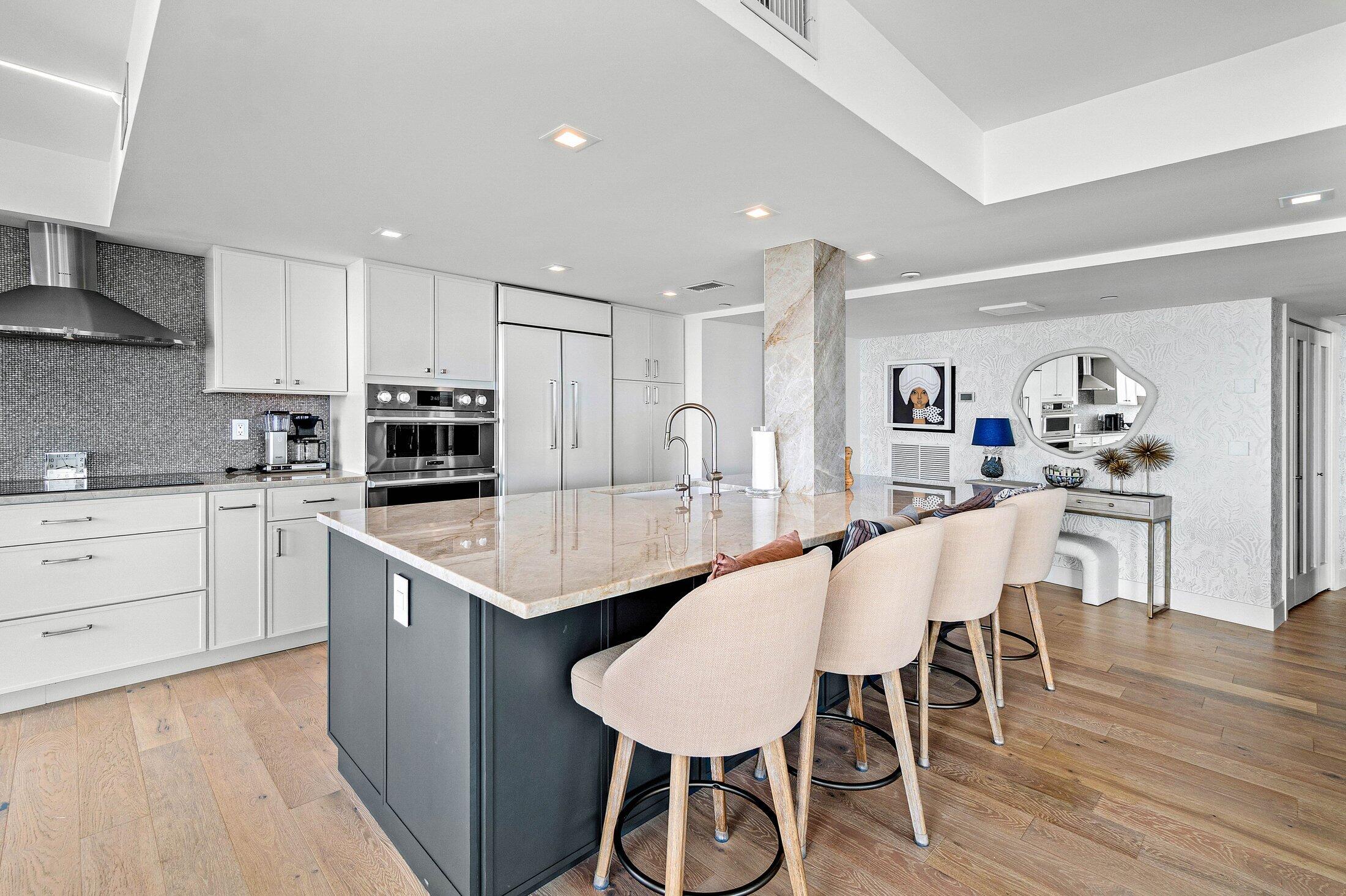 3400 South Ocean Boulevard, Unit 7AII Palm Beach, FL 33480 - Photo 4 of 33 a kitchen with stainless steel appliances granite countertop a table chairs stove a sink dishwasher and cabinets with wooden floor
