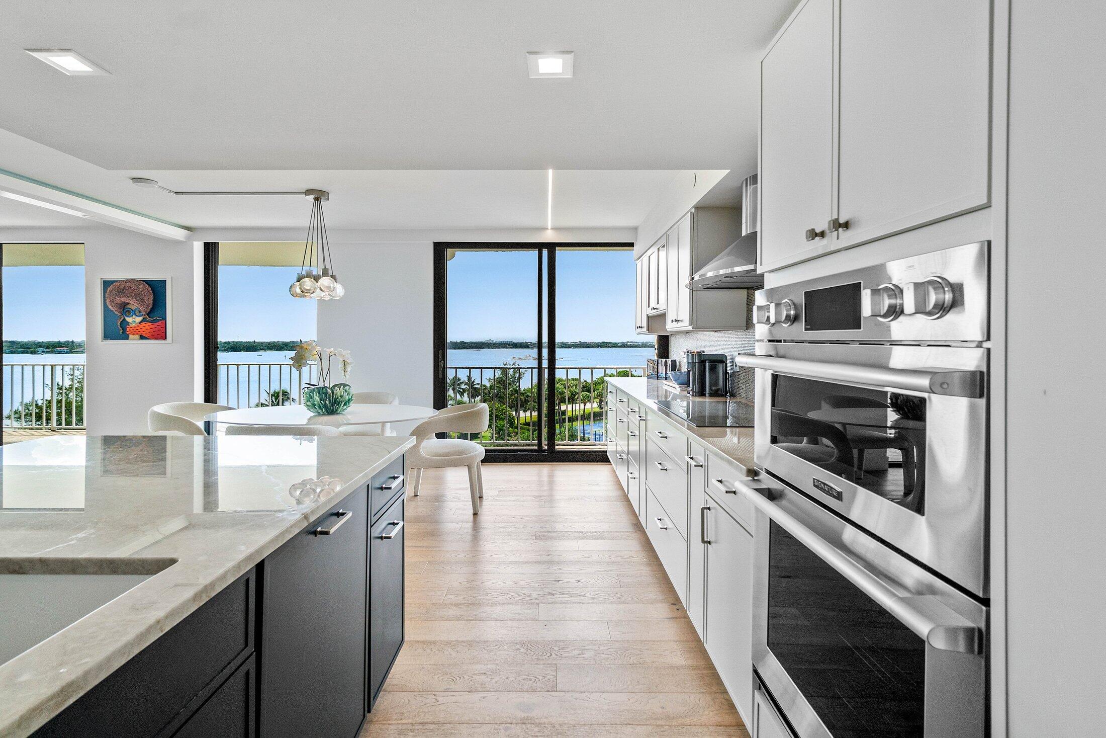 3400 South Ocean Boulevard, Unit 7AII Palm Beach, FL 33480 - Photo 5 of 33 a large kitchen with stainless steel appliances granite countertop lots of counter space and a sink