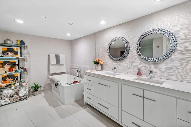 a spacious bathroom with a double vanity sink and a mirror