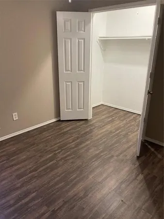 an empty room with wooden floor