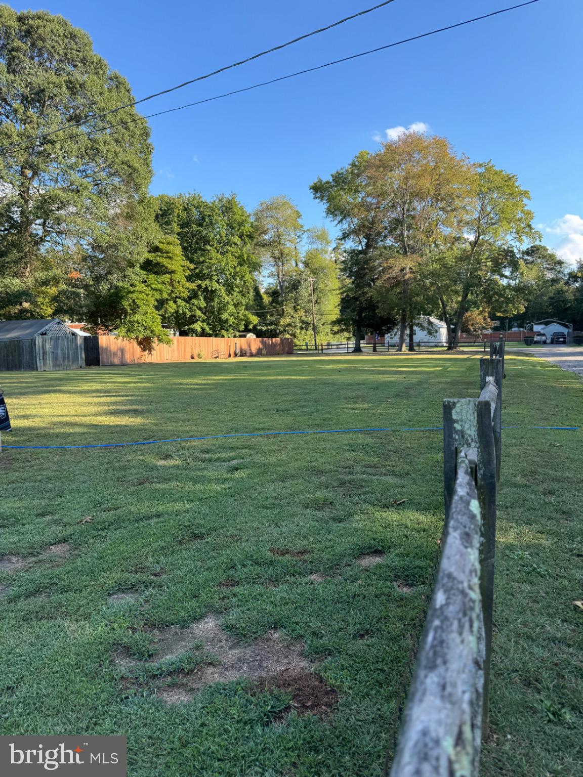 538 Fern Road Millville, NJ 08332 - Photo 7 of 18 Spacious green lot under a clear blue sky.