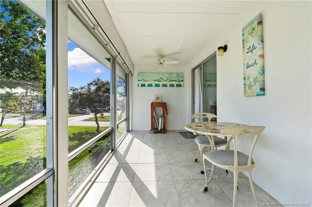 2929 Southeast Ocean Boulevard, Unit 1397 Stuart, FL 34996 - Photo 13 of 38 a dining room with furniture and a floor to ceiling window