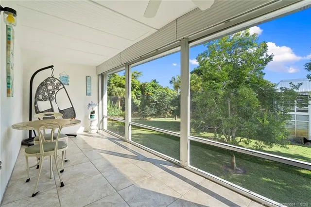 a living room with a large window and furniture