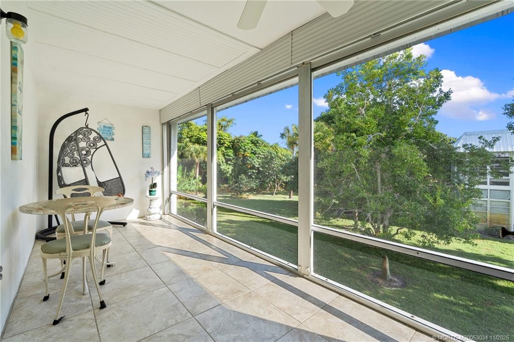 2929 Southeast Ocean Boulevard, Unit 1397 Stuart, FL 34996 - Photo 14 of 38 a living room with a large window and furniture