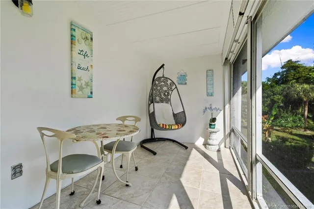 a view of a dining room with a table and chairs