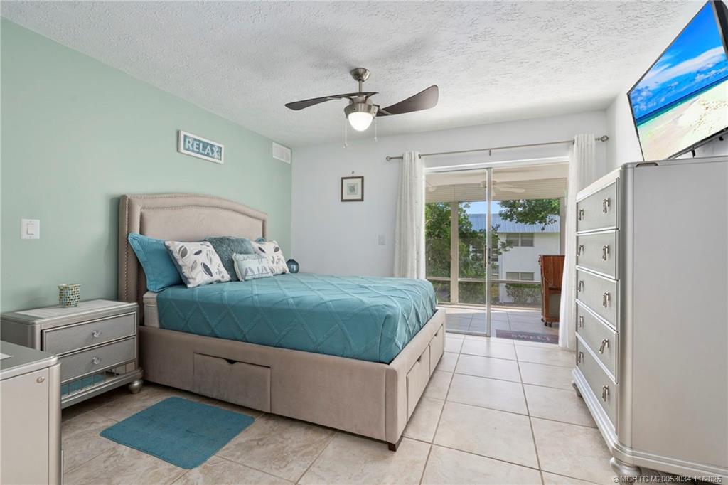 2929 Southeast Ocean Boulevard, Unit 1397 Stuart, FL 34996 - Photo 19 of 38 a bedroom with a bed and a window