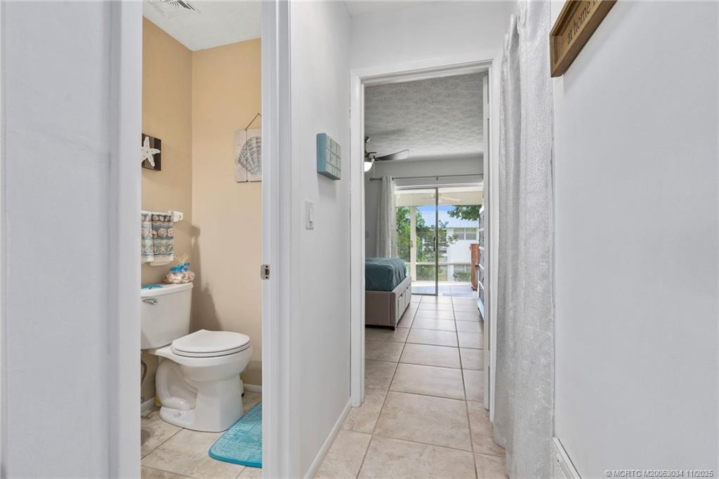 2929 Southeast Ocean Boulevard, Unit 1397 Stuart, FL 34996 - Photo 22 of 38 a bathroom with a toilet and a shower
