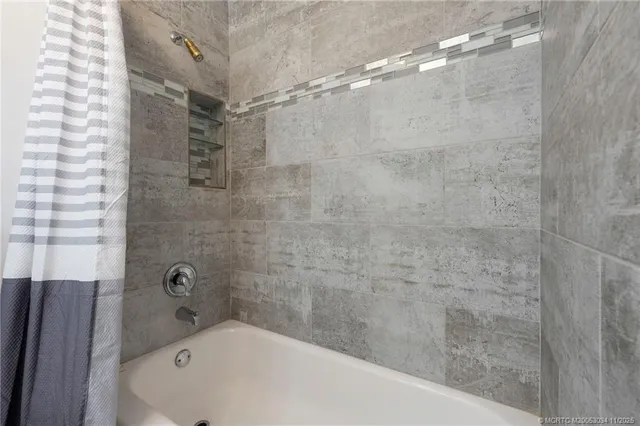 a bathroom with a bathtub and shower