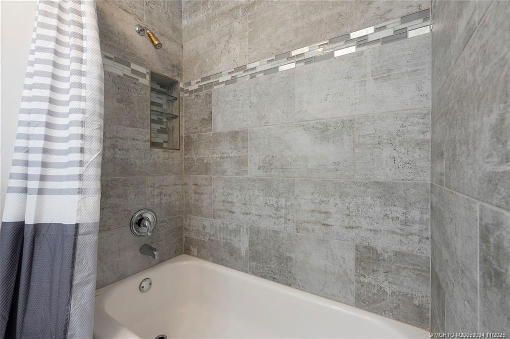 2929 Southeast Ocean Boulevard, Unit 1397 Stuart, FL 34996 - Photo 24 of 38 a bathroom with a bathtub and shower
