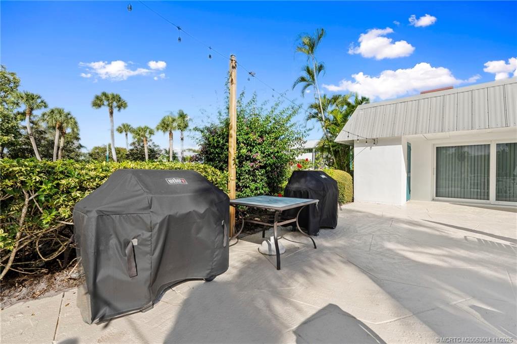 2929 Southeast Ocean Boulevard, Unit 1397 Stuart, FL 34996 - Photo 32 of 38 a view of a patio with table and chairs and potted plants