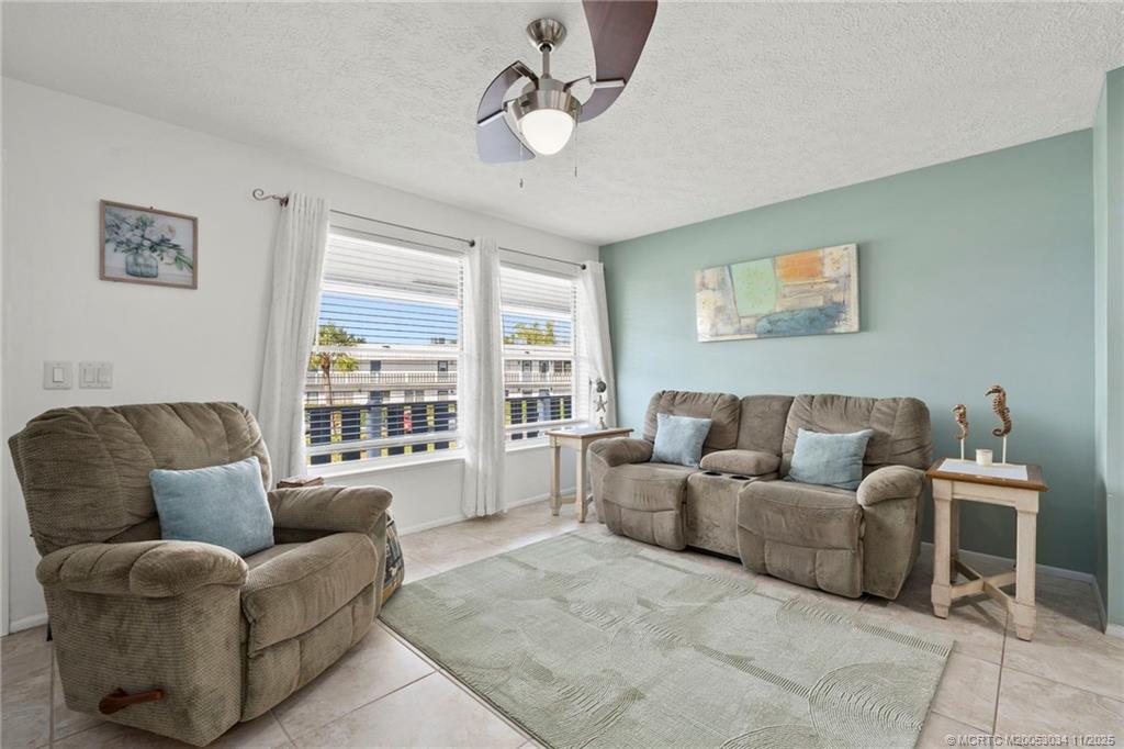2929 Southeast Ocean Boulevard, Unit 1397 Stuart, FL 34996 - Photo 5 of 38 a living room with furniture and a large window