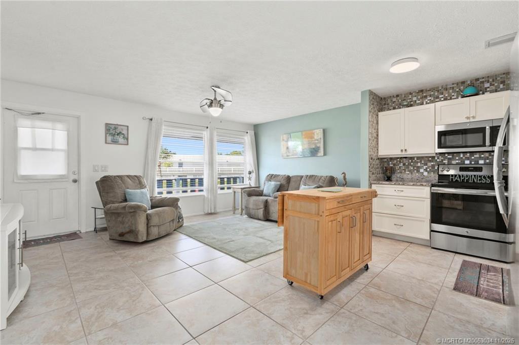 2929 Southeast Ocean Boulevard, Unit 1397 Stuart, FL 34996 - Photo 8 of 38 a living room with furniture and a fireplace