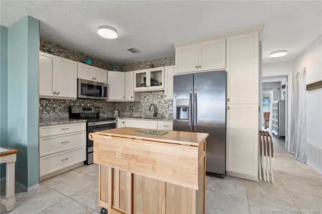 a kitchen with cabinets stainless steel appliances and a counter space