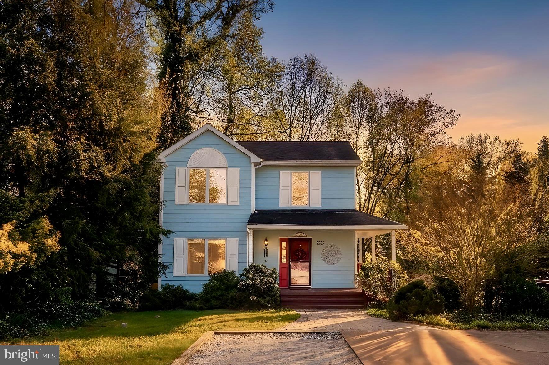 Charming blue home in serene setting.