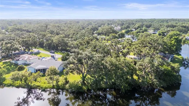 an aerial view of a houses with a yard