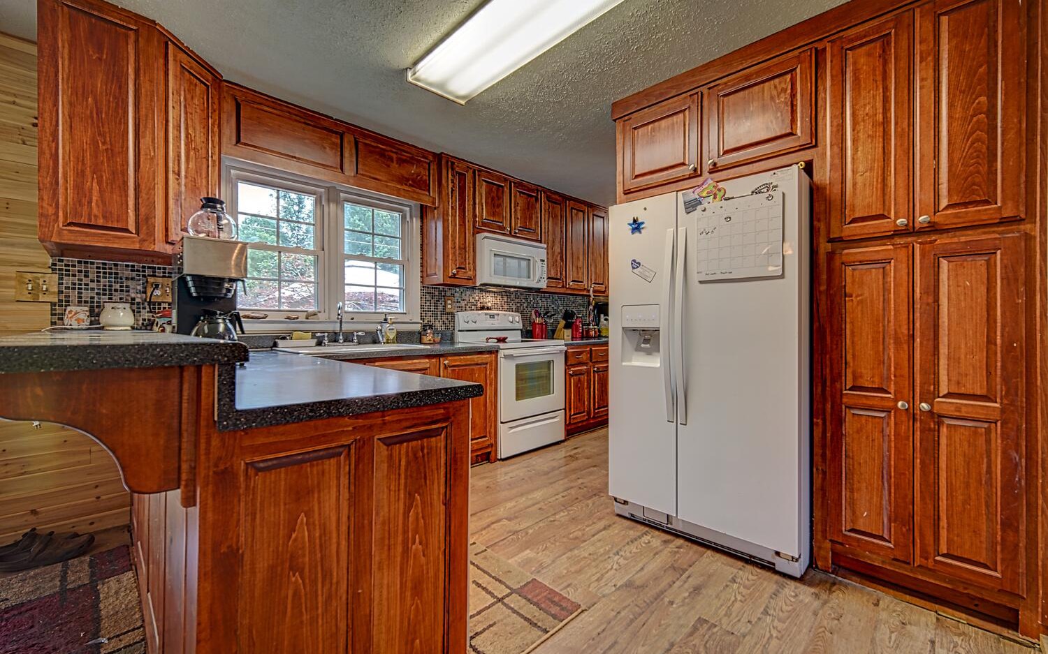 180 Madola Road Epworth, GA 30513 - Photo 4 of 4 a kitchen with stainless steel appliances granite countertop a refrigerator a sink dishwasher and wooden cabinets