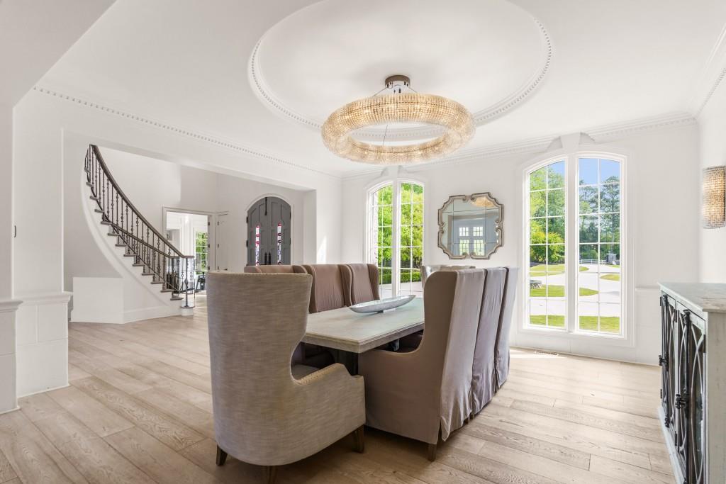 515 Tullamore Way Alpharetta, GA 30004 - Photo 12 of 71 a view of a dining room with furniture a chandelier and wooden floor