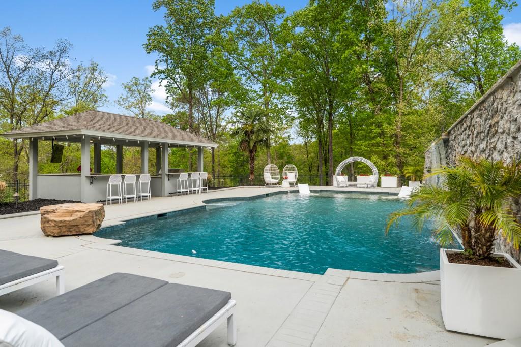 515 Tullamore Way Alpharetta, GA 30004 - Photo 47 of 71 a view of a patio with couches and a table and chairs with plants and trees