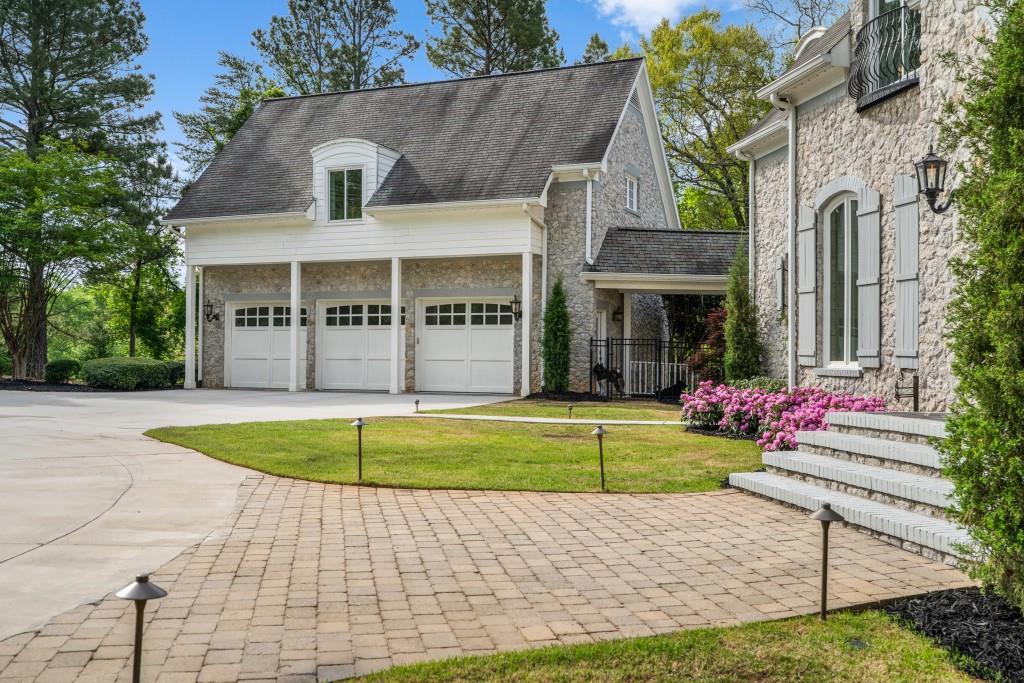 515 Tullamore Way Alpharetta, GA 30004 - Photo 70 of 71 a front view of a house with a yard and trees