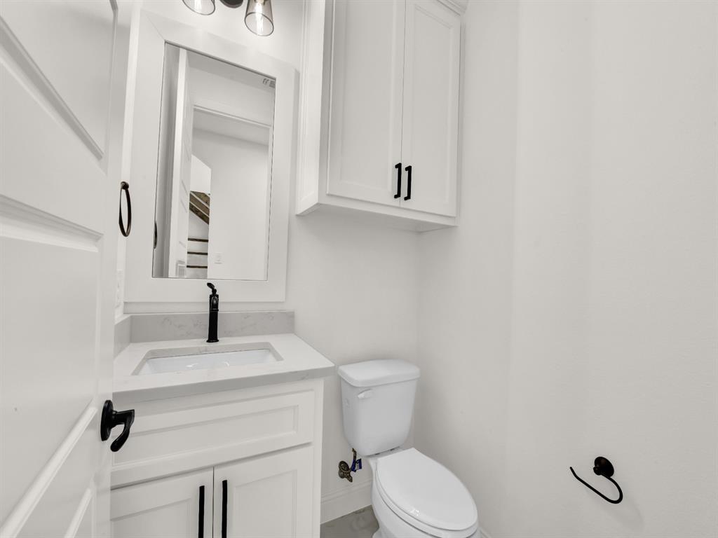 143 Desperado Way Weatherford, TX 76088 - Photo 30 of 36 Bathroom featuring toilet, vanity, and baseboards