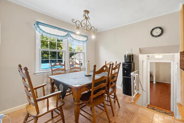 a view of a dining room with furniture and a chandelier