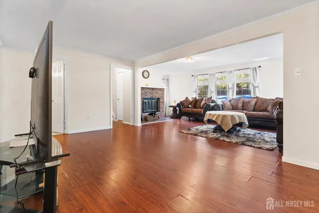 a living room with furniture or wooden floor and a large window