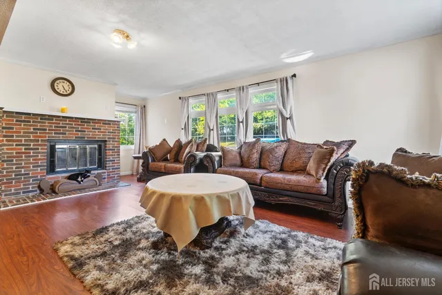 a living room with furniture wooden floor and a fireplace