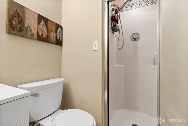 a white toilet sitting next to a bathroom