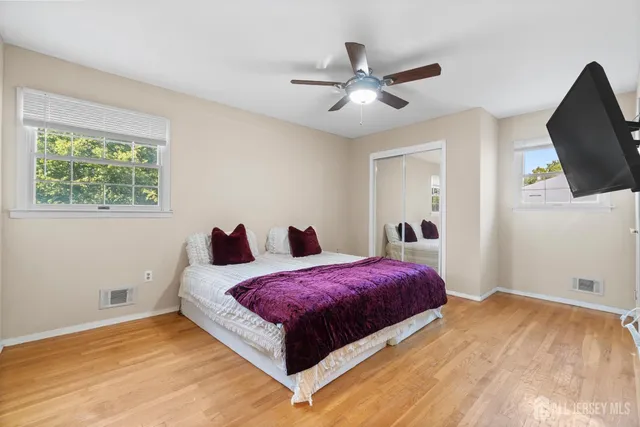 a bedroom with a large bed and a chandelier