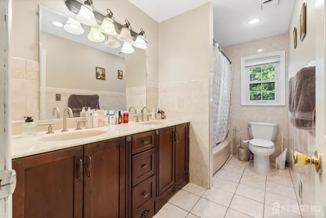 a white toilet sitting next to a bath tub