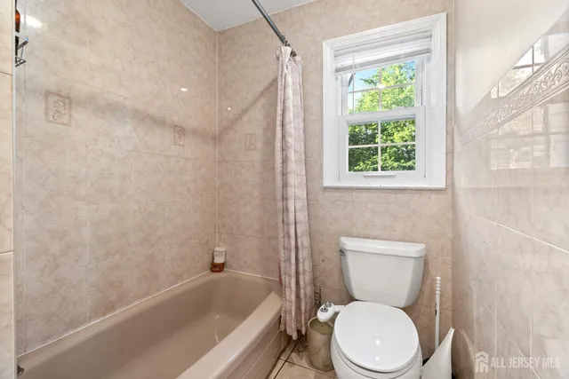 a bedroom with a bed and flat screen tv