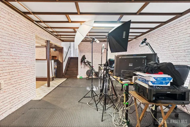 a view of a hallway with a dining table chairs and a refrigerator
