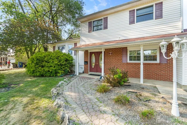 a view of a house with yard and a garden