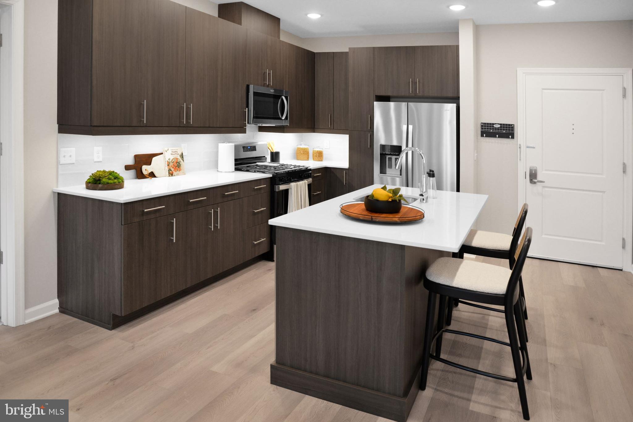 3210 Del Mar Drive Cherry Hill, NJ 08002 - Photo 19 of 27 a kitchen with stainless steel appliances granite countertop a refrigerator a sink a stove and wooden cabinets