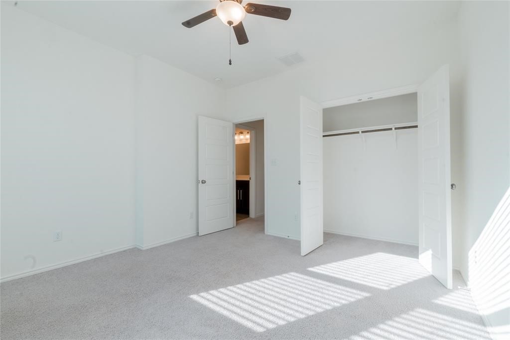 1333 Terrace View Drive Georgetown, TX 78628 - Photo 24 of 35 A well-lit bedroom features plush carpeting, a ceiling fan, and convenient access to a private bathroom.