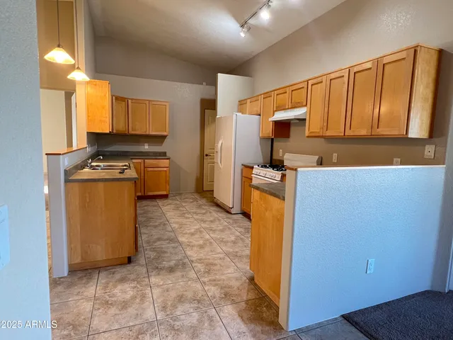 a kitchen with a sink a stove and a refrigerator