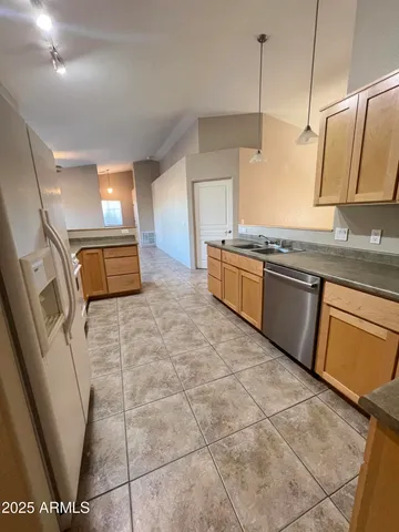 a kitchen with stainless steel appliances granite countertop a sink and a stove