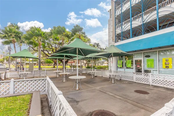 a view of a patio with a table and chairs under an umbrella