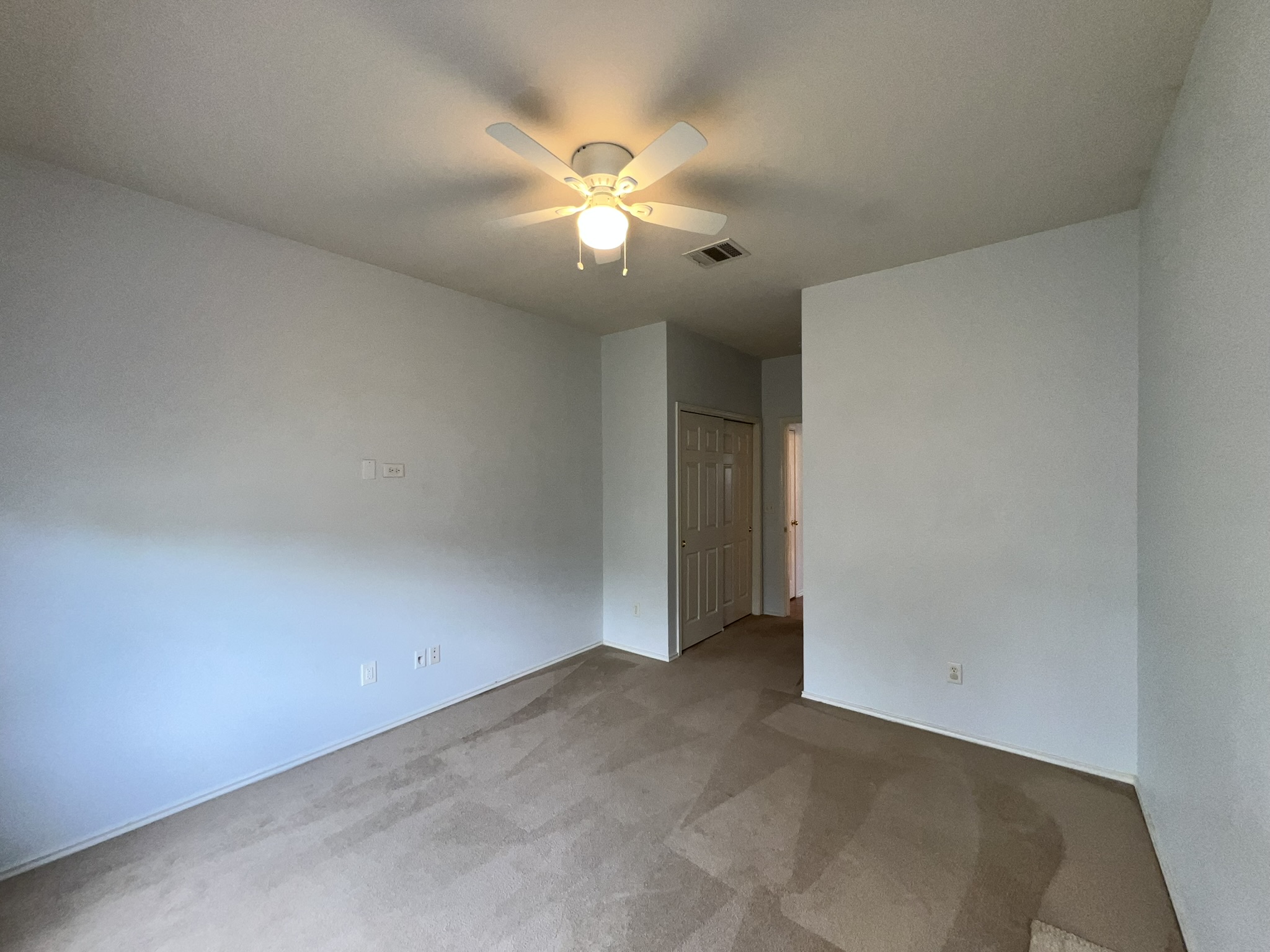 1310 East 3rd Street Georgetown, TX 78626 - Photo 11 of 13 an empty room with a chandelier fan and closet